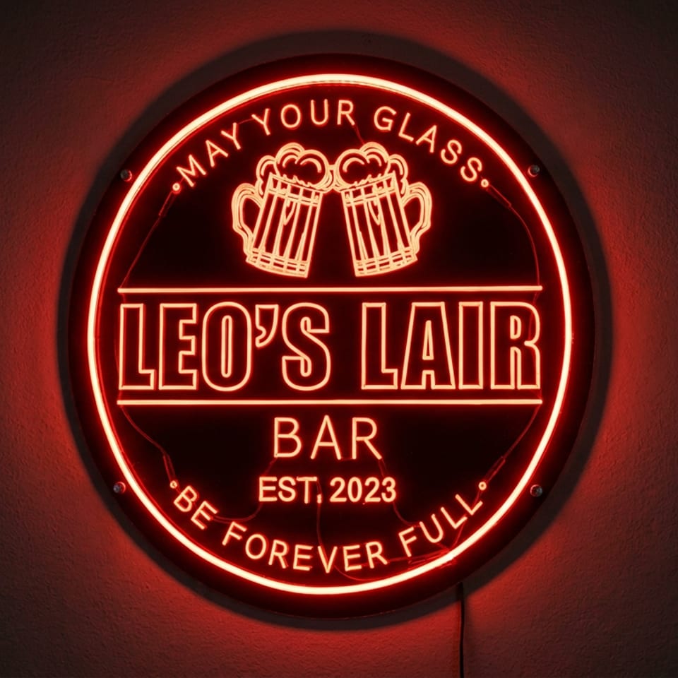 Red neon Leo’s Lair Bar sign featuring clinking beer mugs and the phrases “May Your Glass” and “Be Forever Full.”